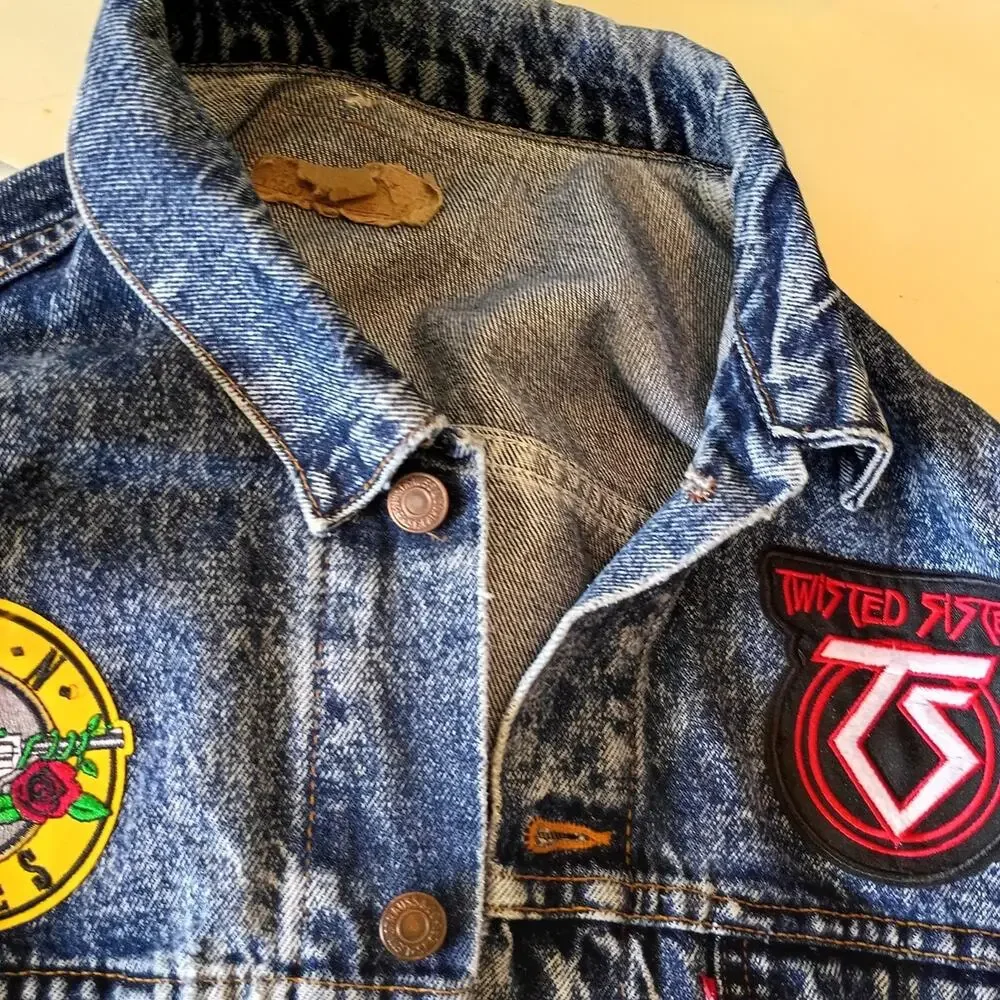 Vintage 1980'S Levi's jean jacket with rock band patches on it. Size large.